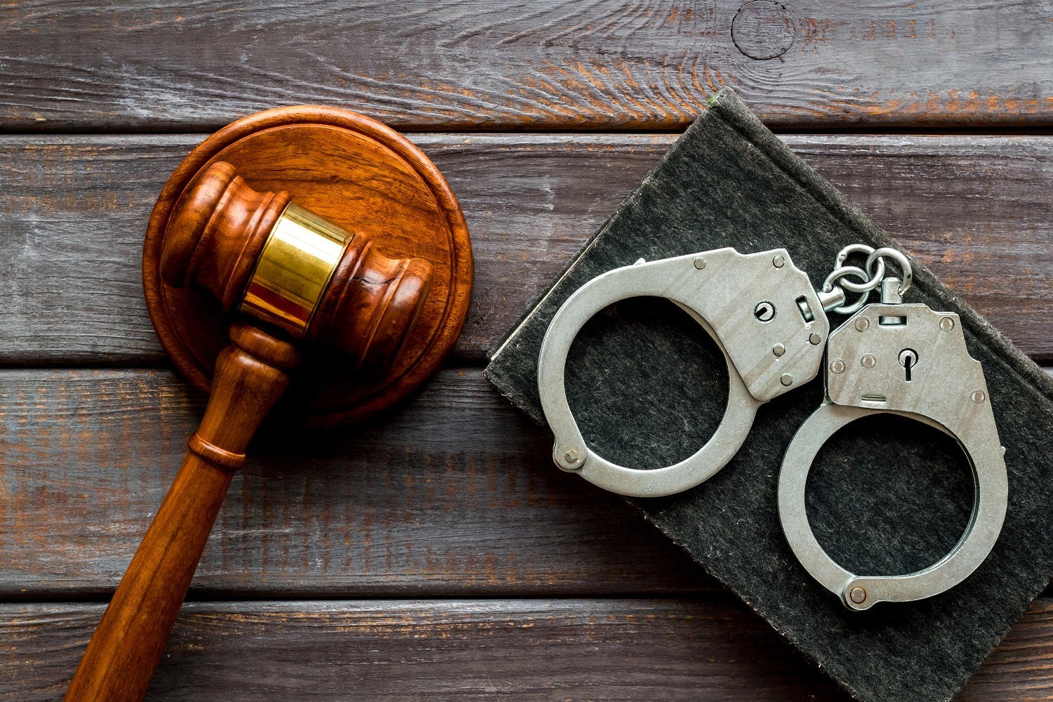 Arrest,Concept.,Handcuffs,Near,Judge,Gavel,On,Dark,Wooden,Background