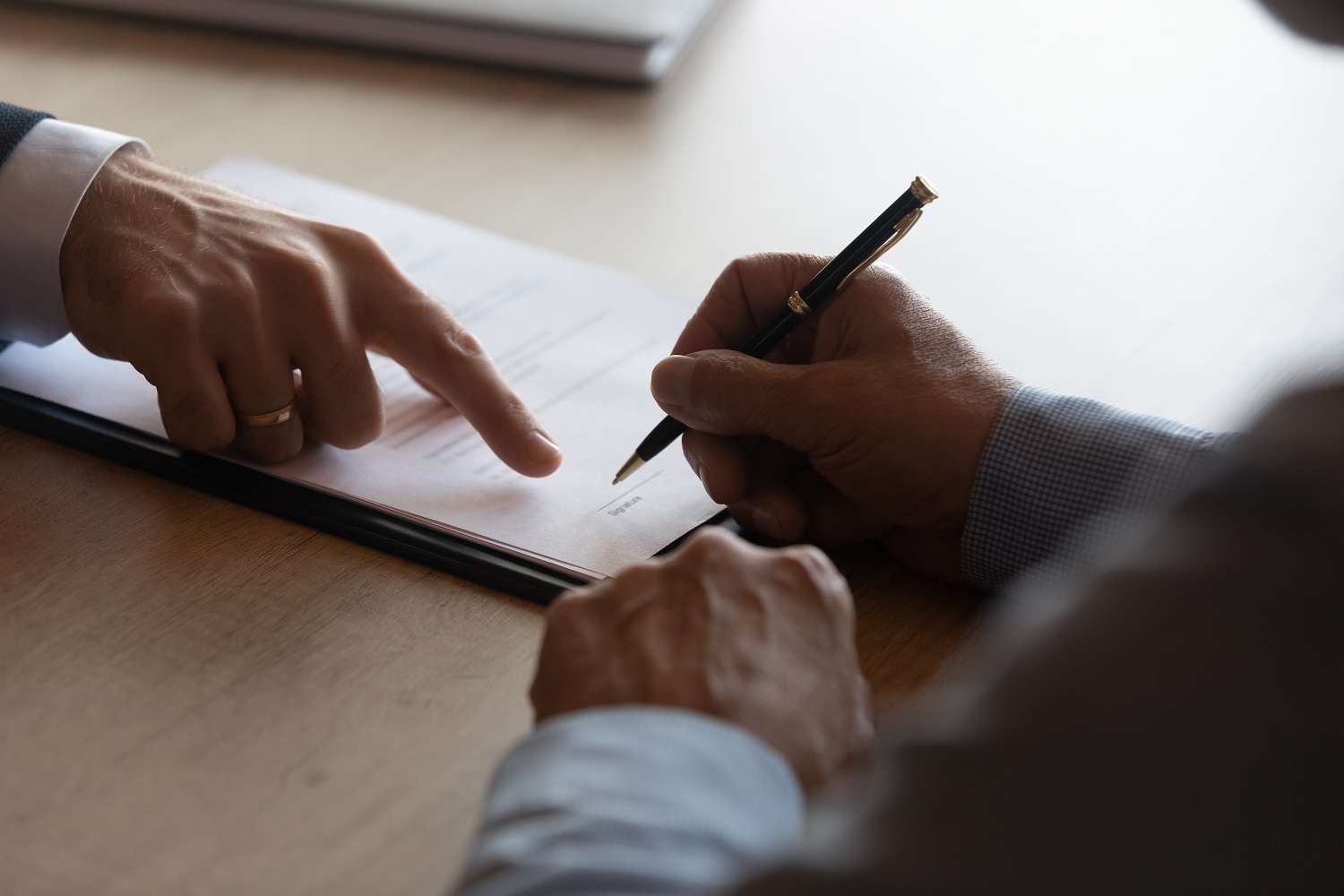 Hands,Of,Lawyer,Pointing,At,Paper,For,Businessman,Signing,Contract.